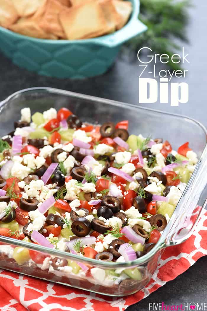 Greek 7-Layer Dip ~ a Mediterranean spin on the beloved, classic recipe, with layers of hummus, dill-infused Greek yogurt, tomatoes, cucumbers, black olives, red onion, and feta cheese! | FiveHeartHome.com