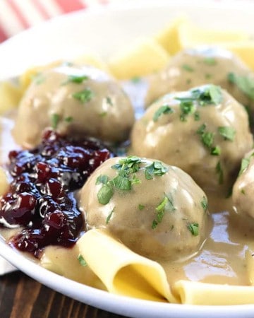 Swedish Meatballs ~ baked in the oven and then simmered in a skillet of creamy homemade gravy, this family-pleasing dinner recipe is both easy and delicious! | FiveHeartHome.com