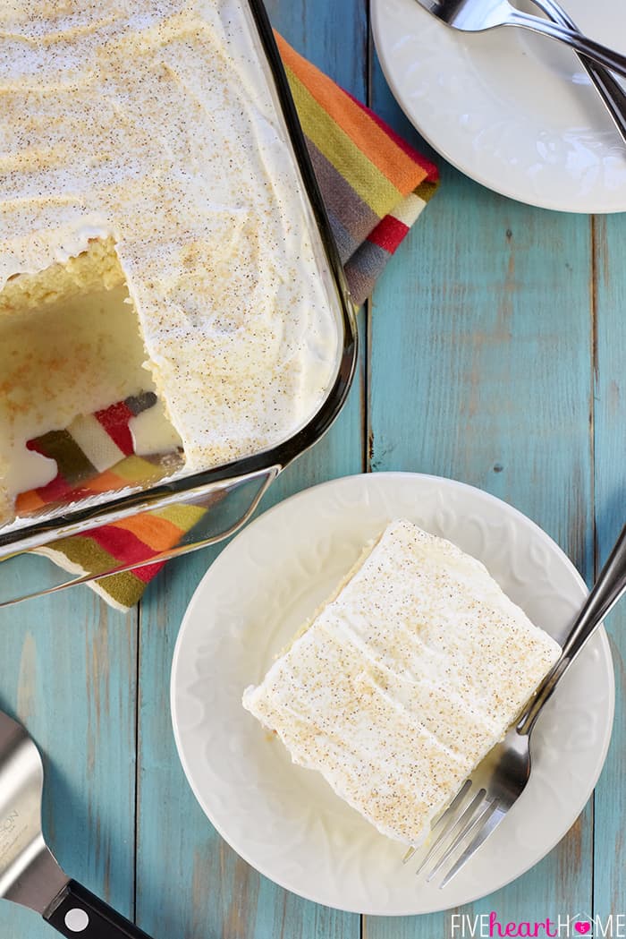 Aerial view of Tres Leches Cake, with one piece cut out and sitting on a white plate