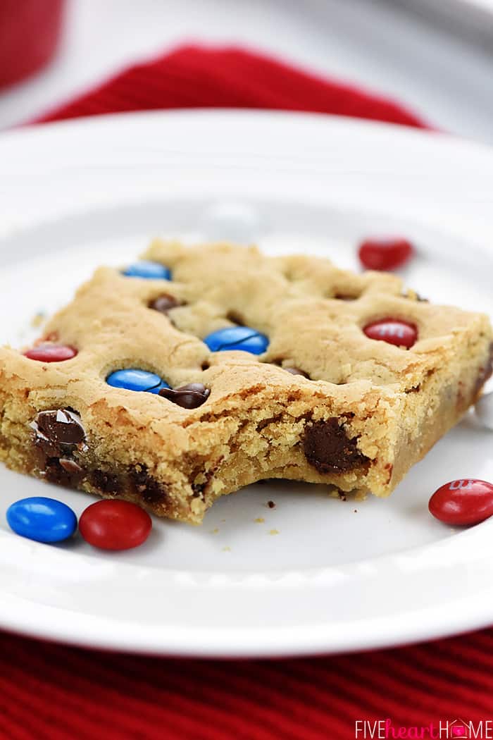 M&M Chocolate Chip Cookies Bars ~ these thick, chewy, big-batch treats are simple to make, fun to share, easy to customize with different colored M&Ms, and always a huge hit! | FiveHeartHome.com Close-up of M&M Bar with bite missing.
