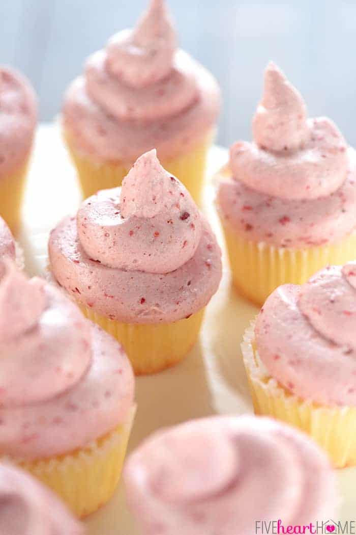 Strawberry Cream Cheese Frosting swirled on vanilla cupcakes