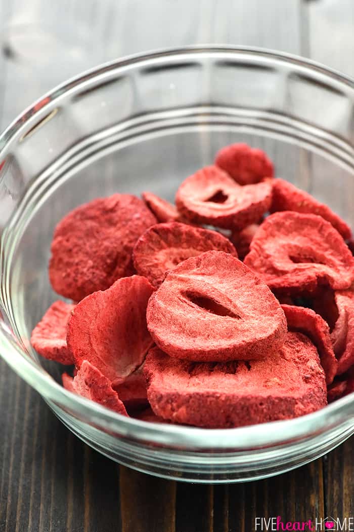 Glass bowl filled with slices of freeze-dried strawberries