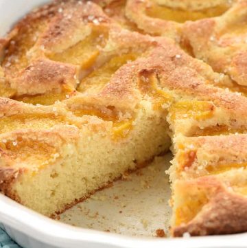 Summer Peach Cake in dish with missing slice.