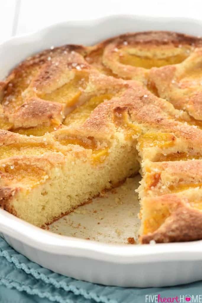 Summer Peach Cake in dish with missing slice.