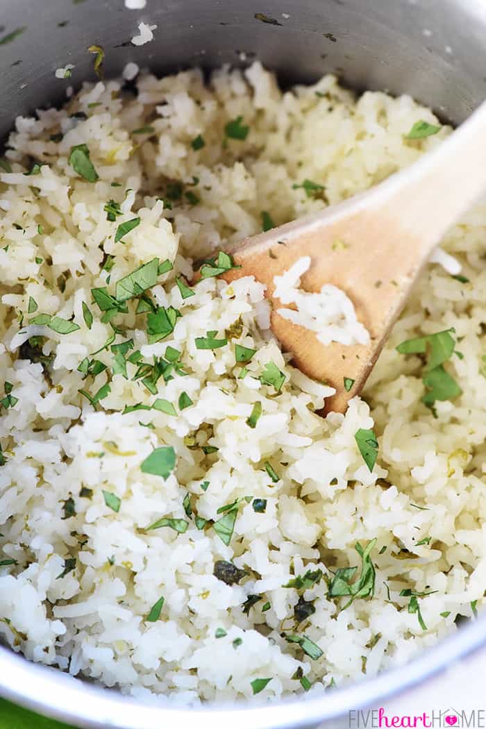 Cilantro Lime Rice ~ with just a handful of ingredients, this easy, tasty recipe is the perfect base for burrito bowls or a delicious side for all of your favorite Mexican entrees! | FiveHeartHome.com Close-up of wooden spoon stirring in pot.