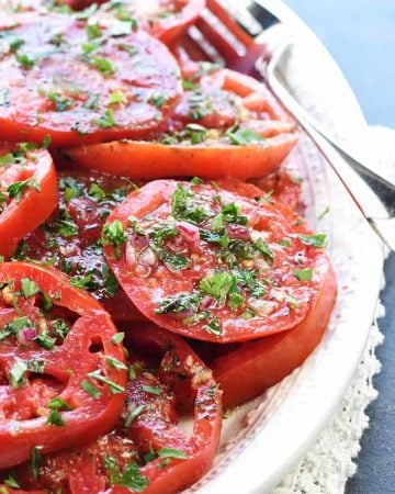 The BEST Marinated Tomatoes ~ ripe, juicy tomatoes soak up olive oil, red wine vinegar, onion, garlic, & fresh herbs in this zesty summer salad or versatile side dish! | FiveHeartHome.com