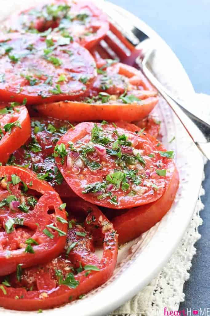 The BEST Marinated Tomatoes ~ ripe, juicy tomatoes soak up olive oil, red wine vinegar, onion, garlic, & fresh herbs in this zesty summer salad or versatile side dish! | FiveHeartHome.com