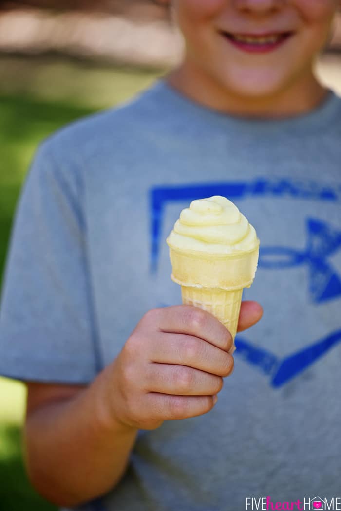 Child holding Pineapple Whip recipe in ice cream cone.
