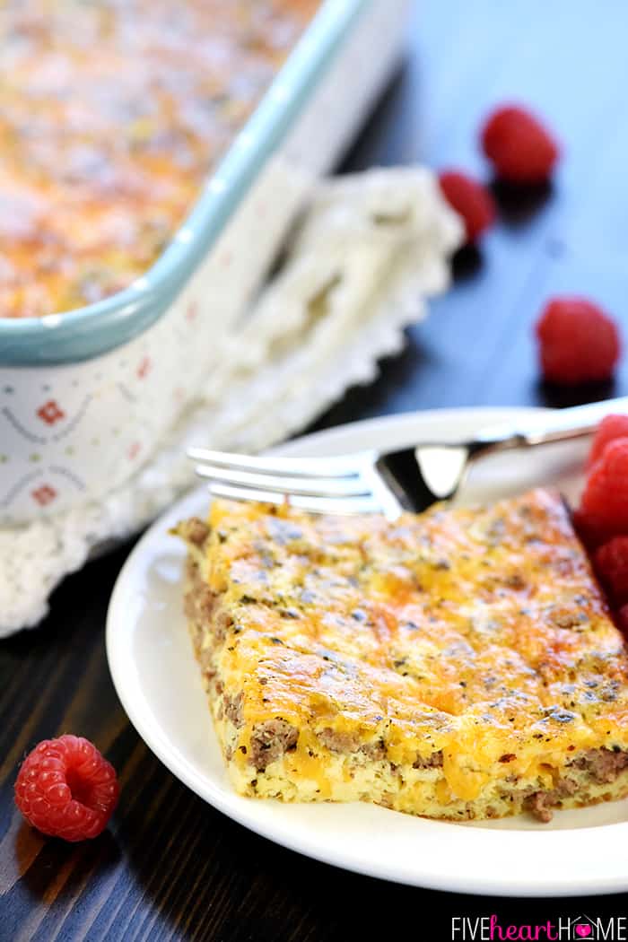 Close-up of Ground Beef Breakfast Casserole on plate with fork and raspberries.