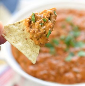 Hot Taco Dip scooped up by a tortilla chip.