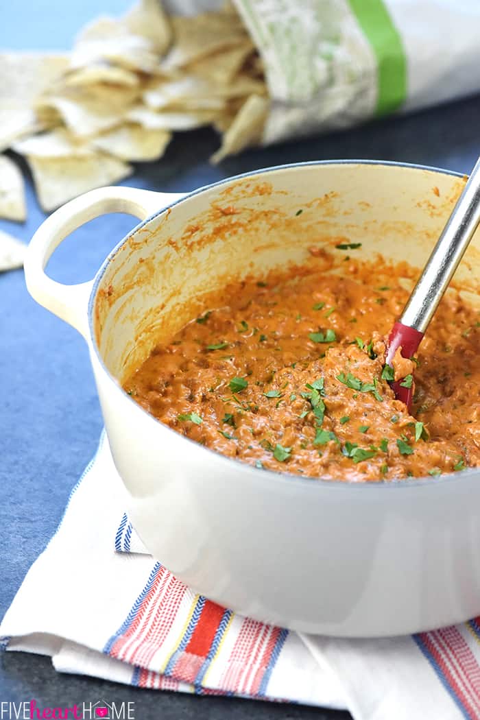 Spoon stirring pot with chips in background.