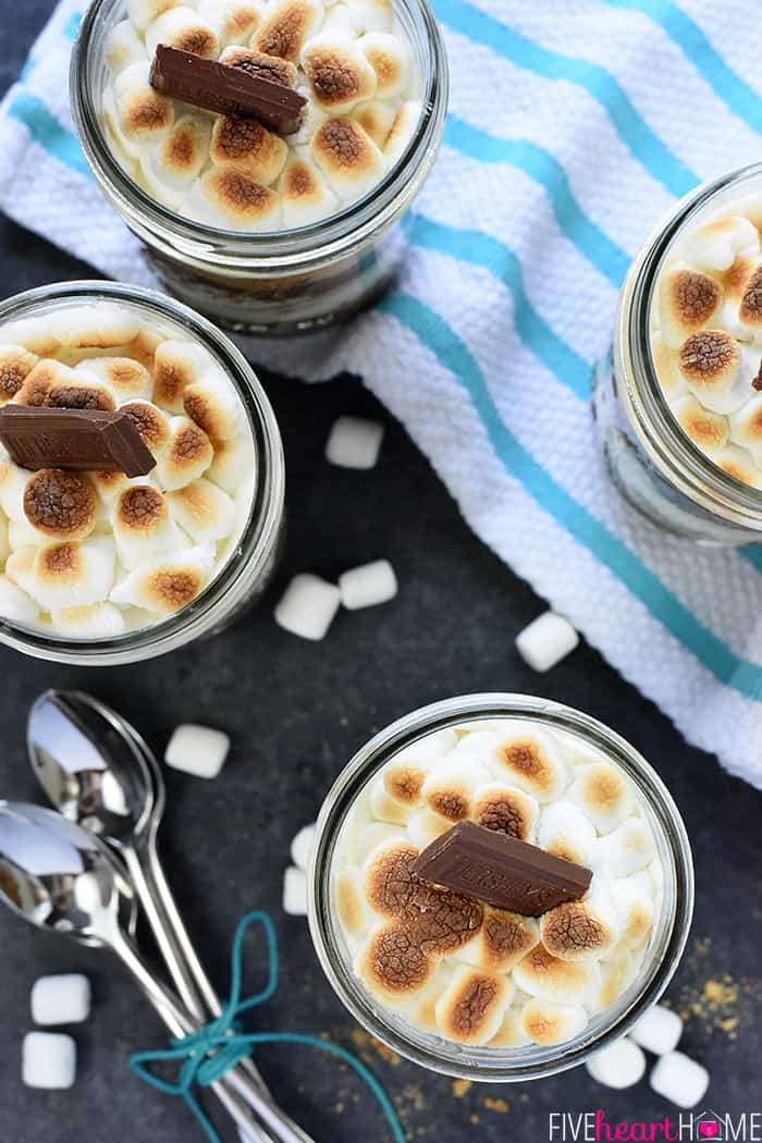 Mini S'mores Trifles ~ layered with rich chocolate pudding, crushed graham crackers, and marshmallow-laced whipped cream for a simple, yummy, no-bake dessert! | FiveHeartHome.com Aerial view of jars.