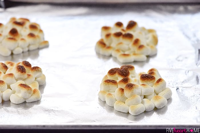 Mini S'mores Trifles ~ layered with rich chocolate pudding, crushed graham crackers, and marshmallow-laced whipped cream for a simple, yummy, no-bake dessert! | FiveHeartHome.com Piles of marshmallows toasted on baking sheet.