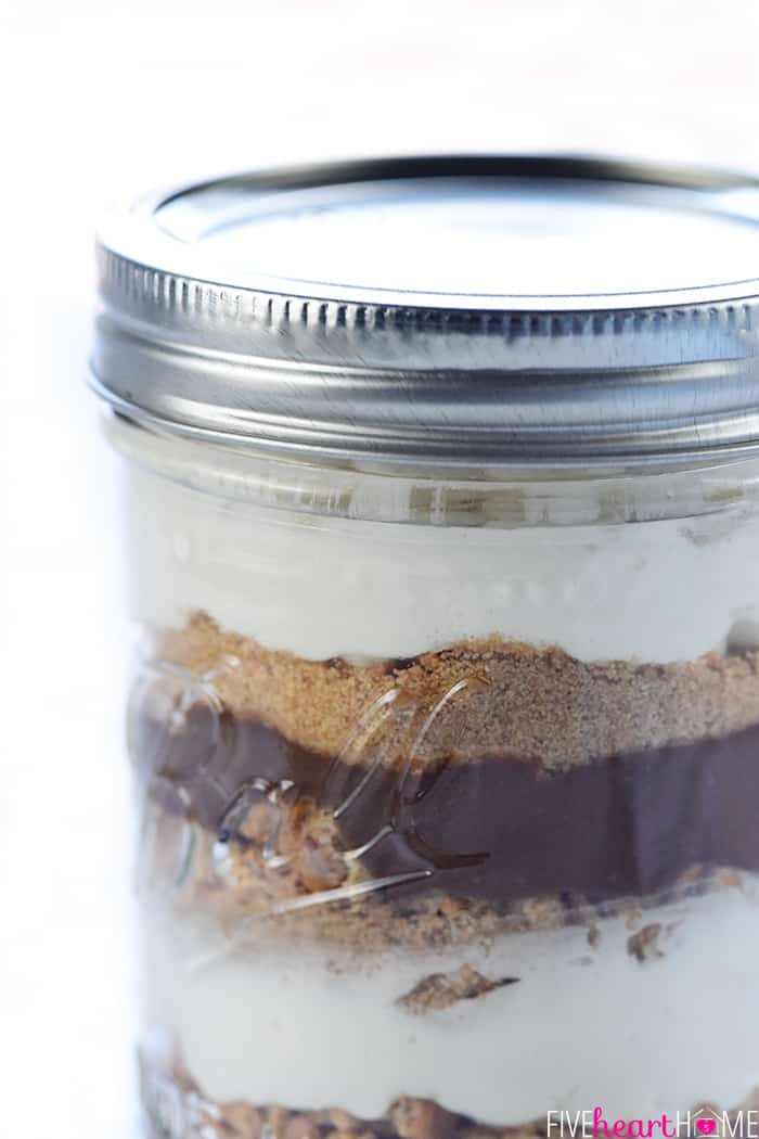 Mini S'mores Trifles ~ layered with rich chocolate pudding, crushed graham crackers, and marshmallow-laced whipped cream for a simple, yummy, no-bake dessert! | FiveHeartHome.com Close-up of layers in jar.