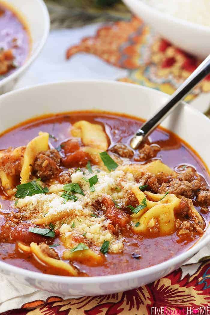 Bowl of Tortellini Lasagna Soup with spoon.