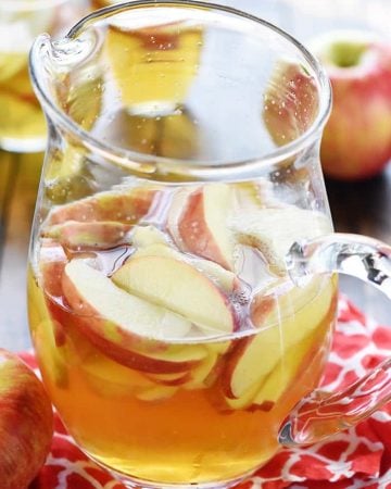 Sparkling Apple Cider Sangria Recipe ~ a festive fall cocktail made with only three ingredients -- white wine, apple cider, and sweet sliced Honeycrisps -- perfect for tailgating, Halloween, Thanksgiving, and even Christmas! | FiveHeartHome.com