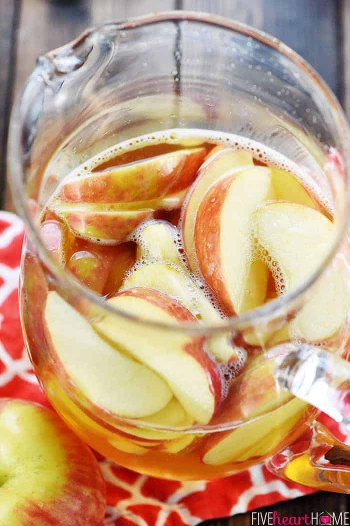 Sparkling Apple Cider Sangria ~ a festive fall cocktail recipe with just three ingredients -- white wine, apple cider, and sweet sliced Honeycrisps -- perfect for tailgating, Halloween, Thanksgiving, and even Christmas! | FiveHeartHome.com Aerial view of pitcher