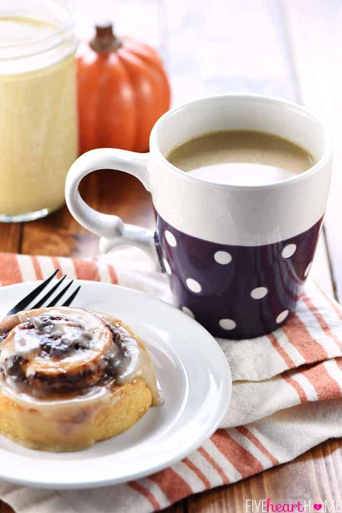 Mug of coffee, cinnamon roll, and jar of Pumpkin Spice Creamer