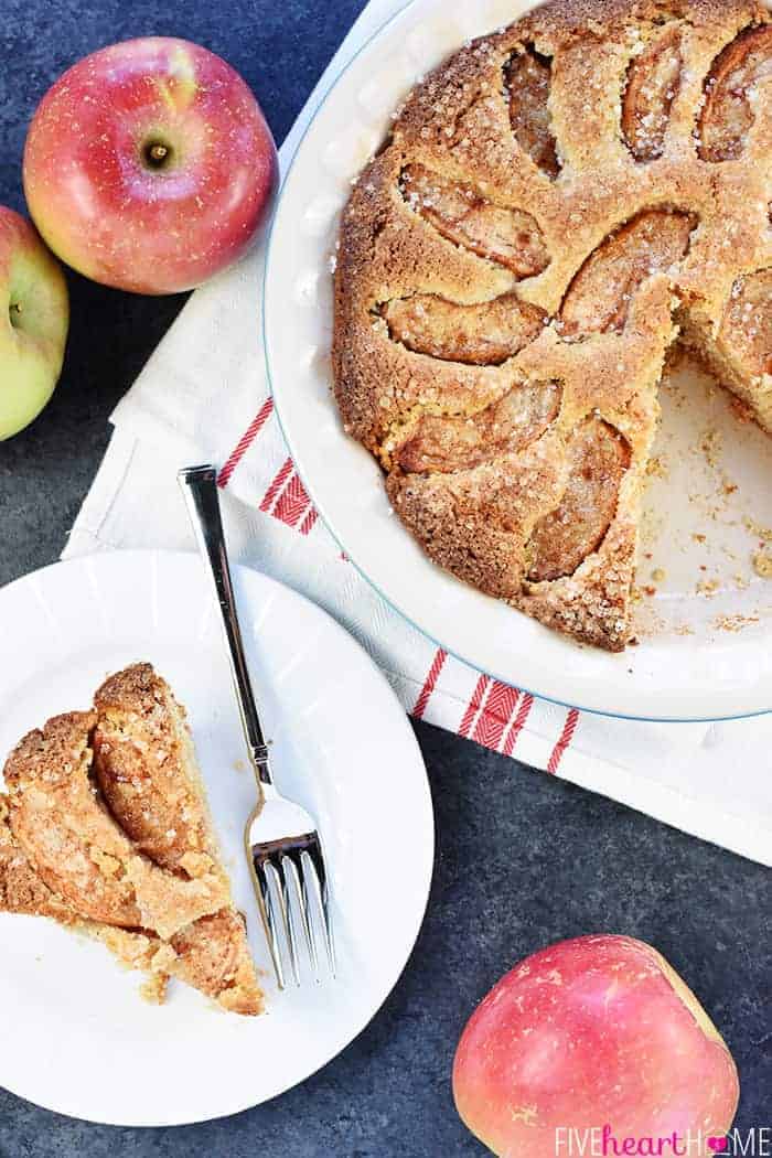 Aerial View of Apple Cake with Slice on White Plate next to Cake