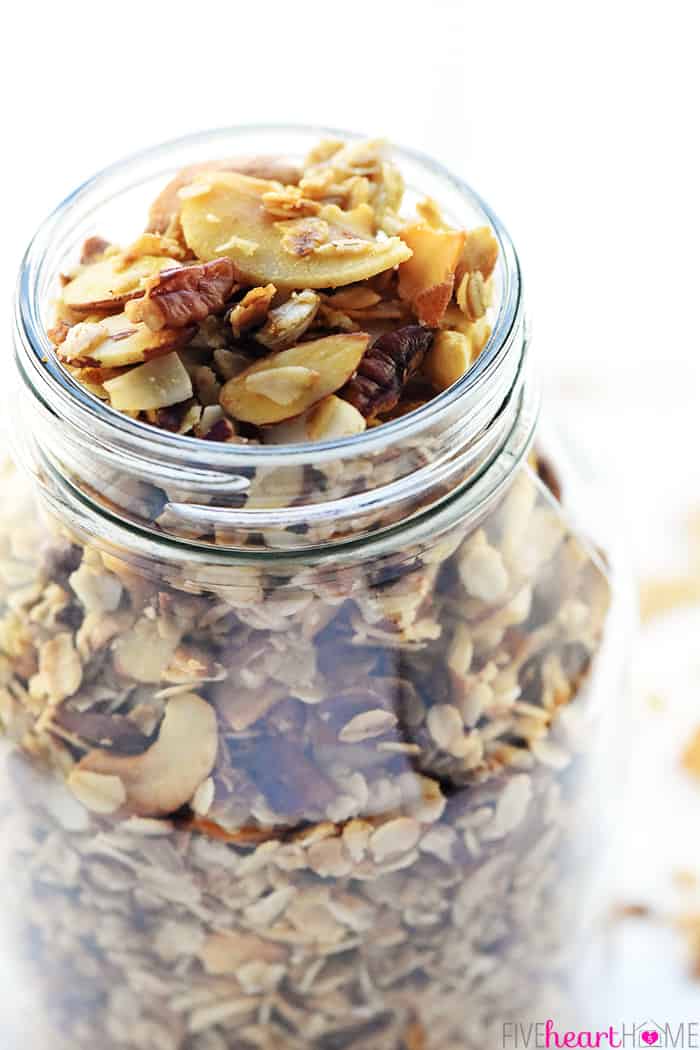 Glass jar full of Slow Cooker Granola.