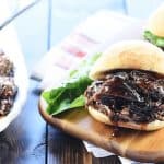 Slow Cooker Honey Balsamic Shredded Beef Sandwiches on wooden board.
