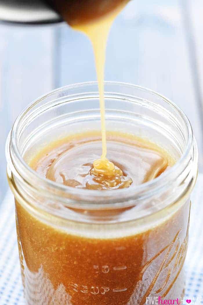 Caramel Sauce being poured into glass jar.
