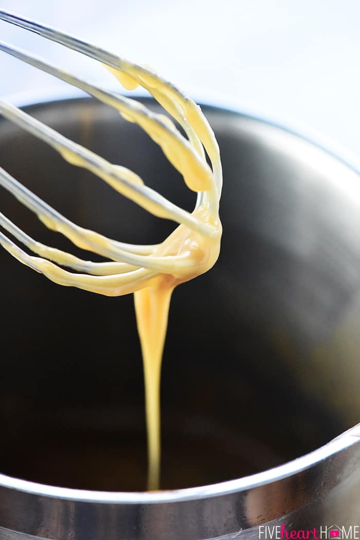 Easy Homemade Caramel Sauce ~ this is the BEST caramel sauce recipe...thick, gooey, and made with just FIVE ingredients in only FIVE minutes! It makes a perfect caramel dip for apples, it's delicious drizzled over brownies or ice cream, and it's even great as a homemade food gift! | FiveHeartHome.com Close-up of coated whisk.