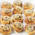 White serving tray of Blue Cheese Cranberry Pecan Crescent Pinwheels.