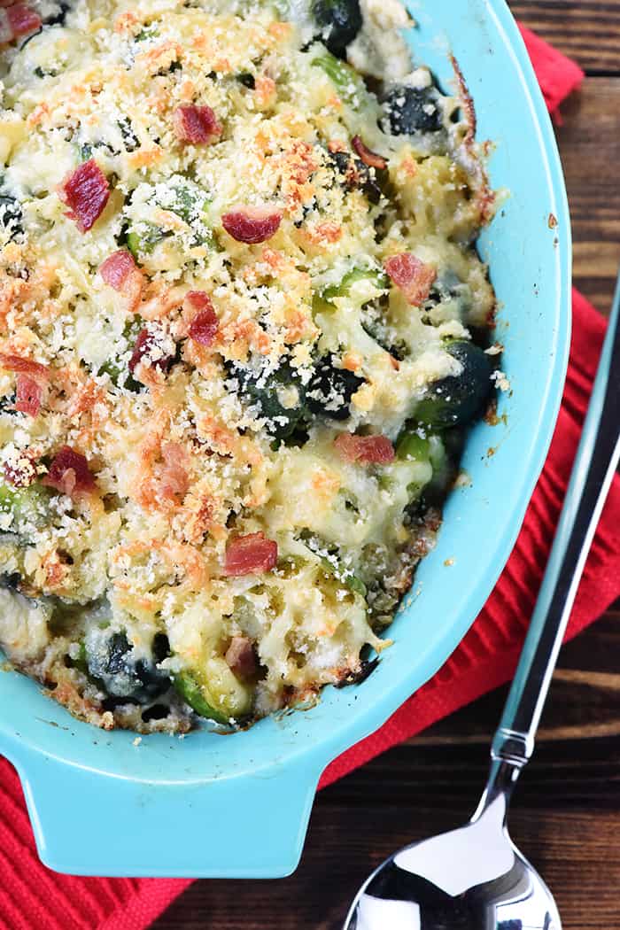 Brussels Sprouts with Bacon ~ a cheesy, decadent, delicious gratin recipe loaded with bacon, Gruyere, and crunchy breadcrumbs...the perfect side dish for dinner parties or holiday menus! | FiveHeartHome.com Aerial view of light dish of Brussels Sprouts Gratin.