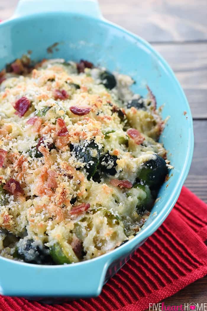Brussels Sprouts with Bacon ~ a cheesy, decadent, delicious gratin recipe loaded with bacon, Gruyere, and crunchy breadcrumbs...the perfect side dish for dinner parties or holiday menus! | FiveHeartHome.com Brussels Sprouts Gratin in light blue oval baking dish.