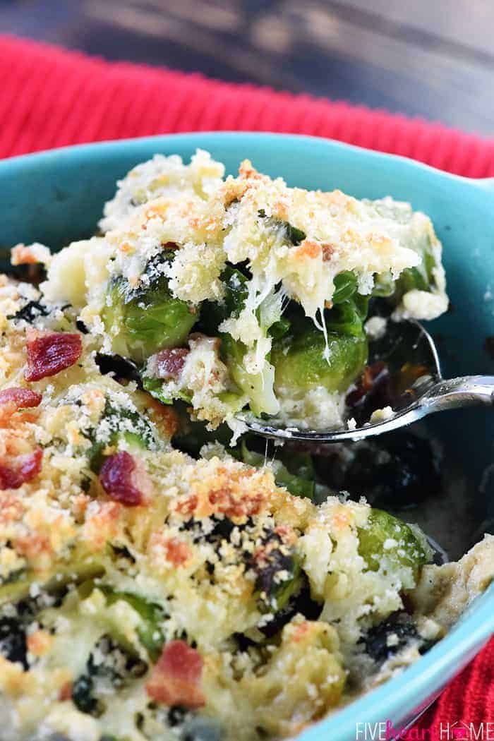 Close-up on spoon scooping up Brussels Sprouts Gratin with bacon, cheese, and breadcrumbs.