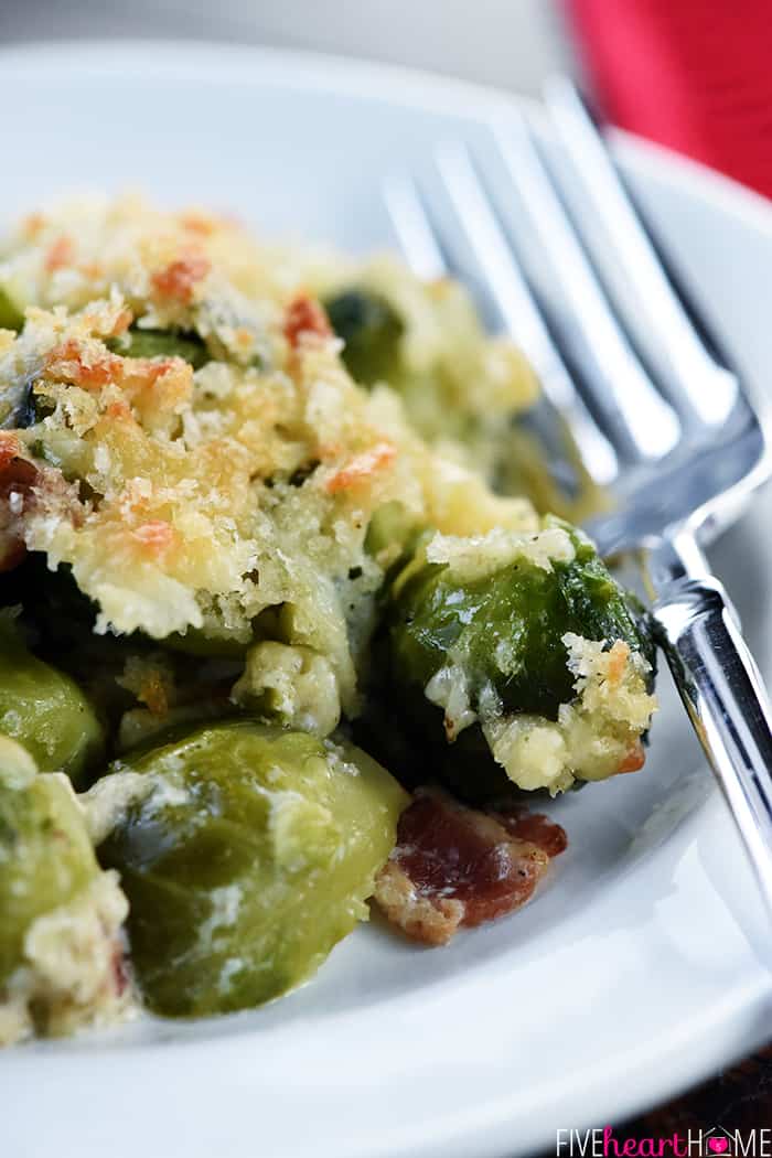 Brussels Sprouts with Bacon ~ a cheesy, decadent, delicious gratin recipe loaded with bacon, Gruyere, and crunchy breadcrumbs...the perfect side dish for dinner parties or holiday menus! | FiveHeartHome.com Close-up of Brussels Sprouts Gratin on plate.