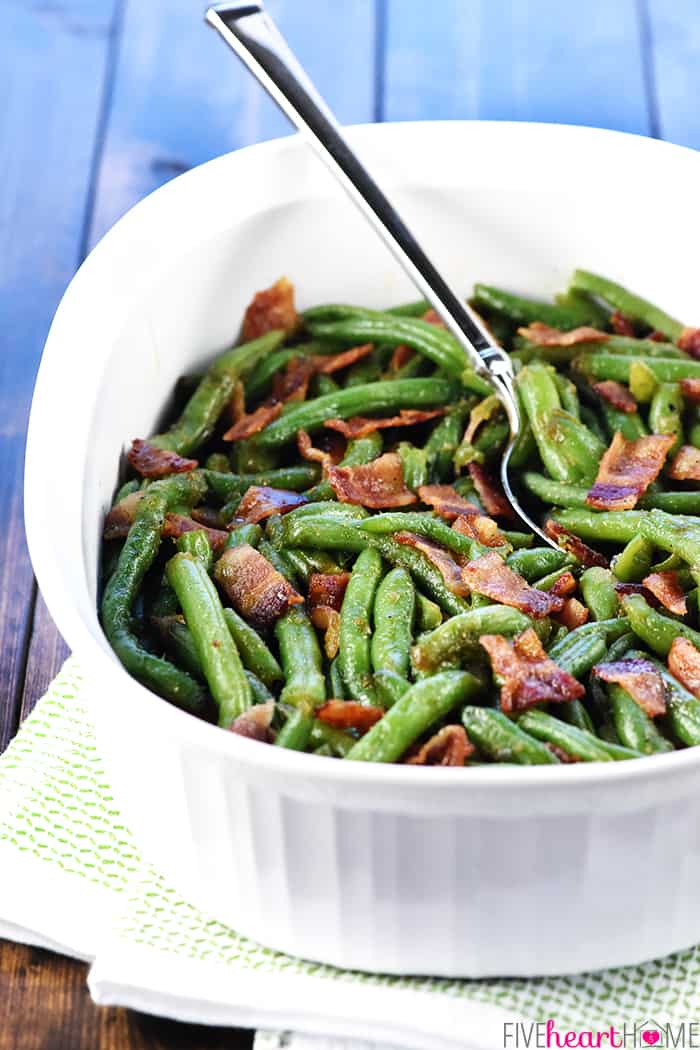 Green Beans with Bacon in serving dish with spoon.