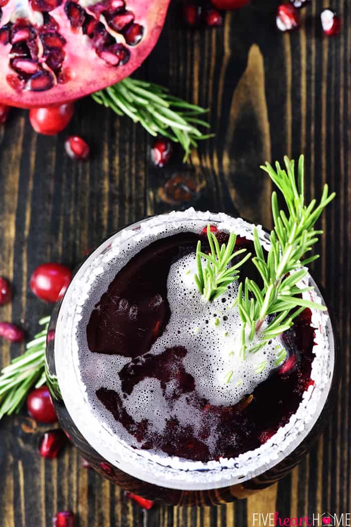 Easy Christmas Punch ~ a festive, sparkling, boozy holiday beverage featuring champagne, pomegranate juice, and cranberry juice that's perfect for Christmas or New Year's Eve parties...and it's easy to make a non-alcoholic version as well! | FiveHeartHome.com Aerial view of Christmas Punch in glass with rosemary garnish.