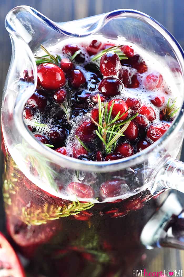 Easy Christmas Punch ~ a festive, sparkling, boozy holiday beverage featuring champagne, pomegranate juice, and cranberry juice that's perfect for Christmas or New Year's Eve parties...and it's easy to make a non-alcoholic version as well! | FiveHeartHome.com Close-up of Christmas Punch in pitcher.