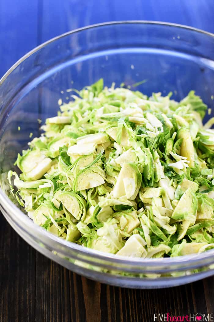 Shaved Brussels Sprouts in glass bowl.