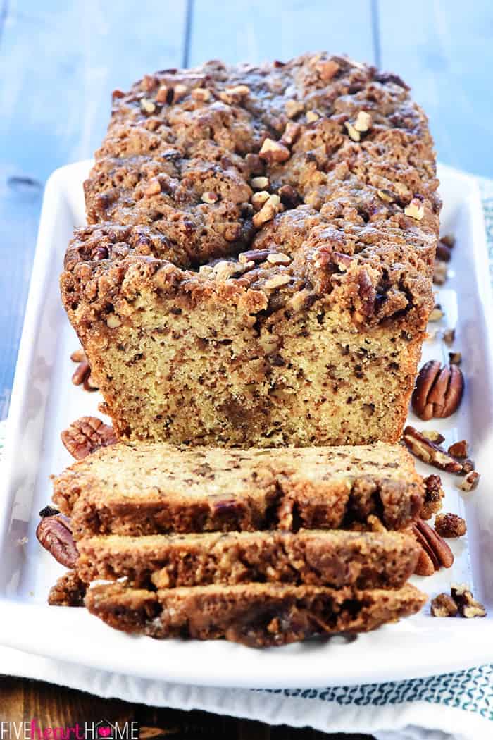 Sliced loaf of Pecan Praline Bread on white platter.