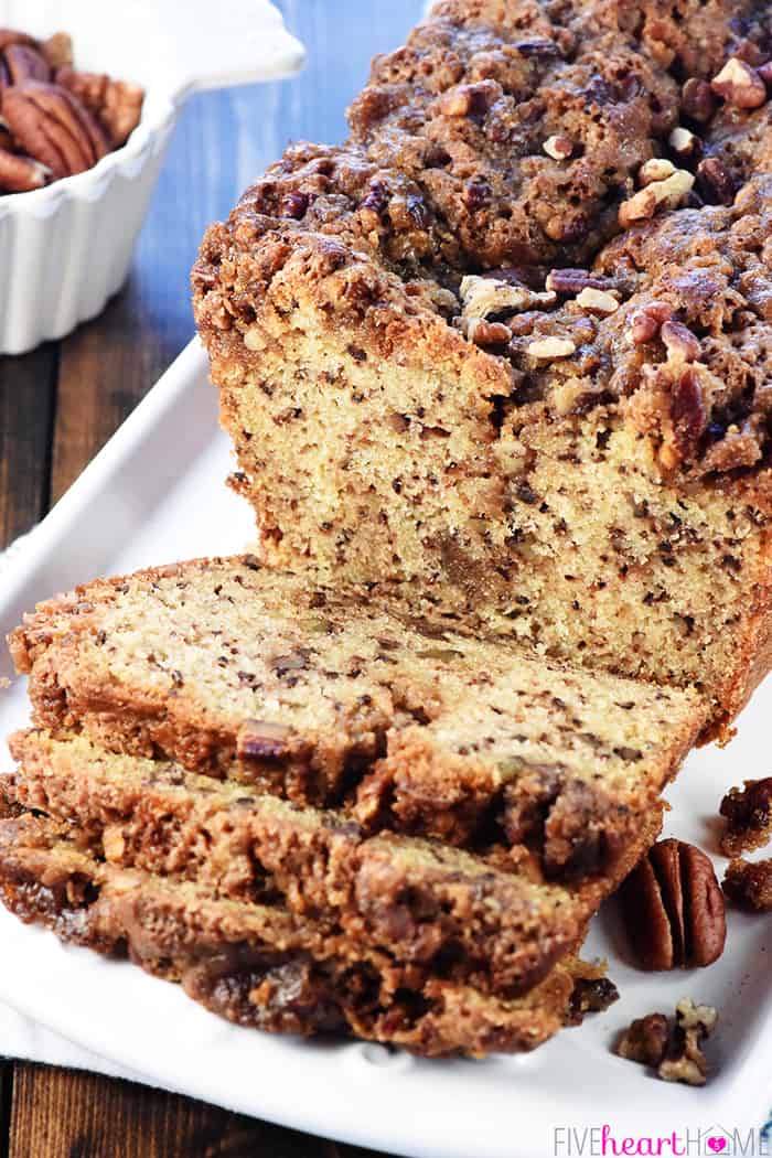 Pecan Bread sliced on platter, showing praline swirl inside.