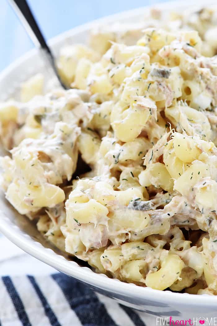 Close-up of Tuna Pasta Salad in serving bowl with spoon.
