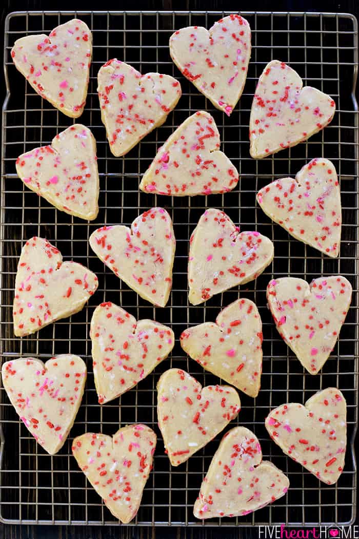 Aerial view of Easy Shortbread Heart-Shaped Cookies with Valentine sprinkles on cooling rack.
