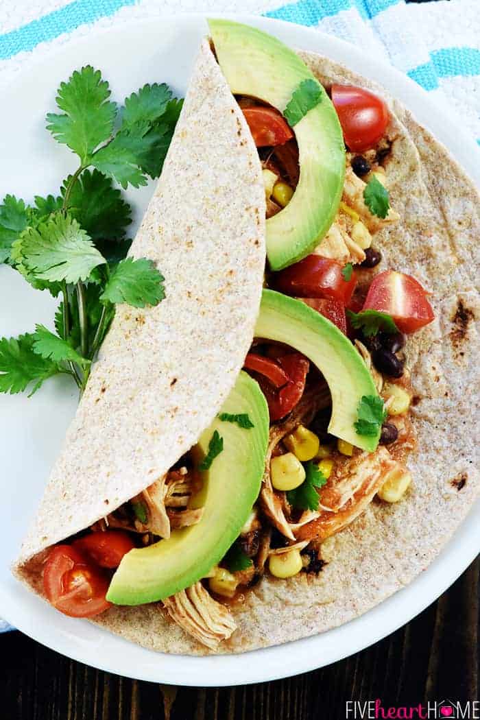 Aerial view of Instant Pot Chicken Tacos on plate with cilantro garnish.