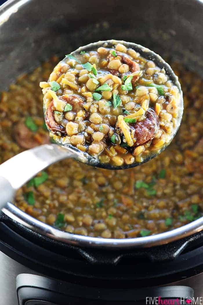 Instant Pot German Lentil Soup in ladle over pressure cooker.