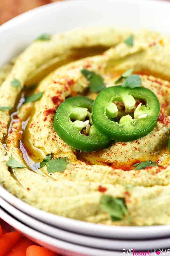 Jalapeno Hummus is Whole Foods shown here with sliced jalapeños