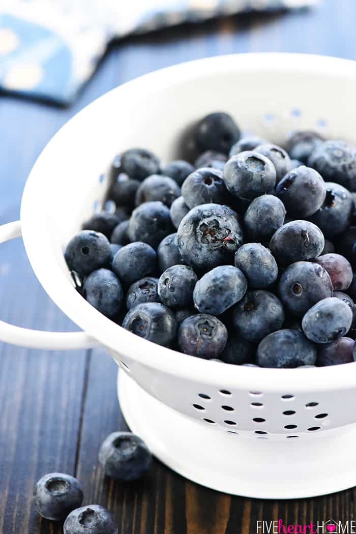 Brain Healthy Salad ~ loaded with leafy greens, blueberries, walnuts, and extra-virgin olive oil for an easy, tasty way to enjoy brain-protective foods in your diet! | FiveHeartHome.com Colander of fresh blueberries.