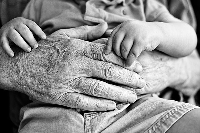 Daddy's hands hugging toddler.