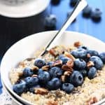 Steel cut oats in bowl with fresh blueberries and pecans.