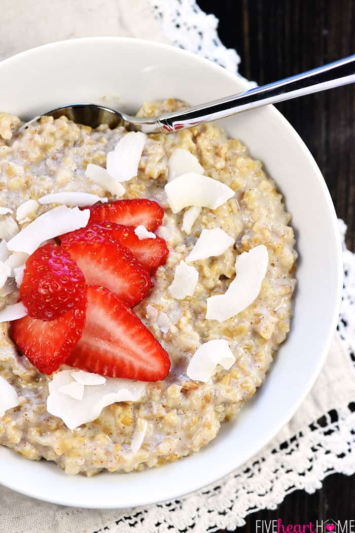 Aerial bowl with of Steel Cut Oats topped with strawberries and coconut.