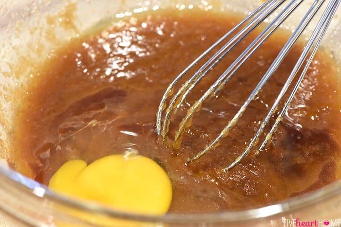 Adding eggs and vanilla to the batter.