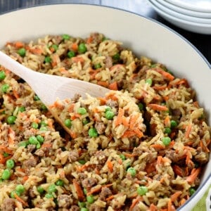 One-Pan Asian Ground Beef and Rice recipe in skillet with wooden spoon.