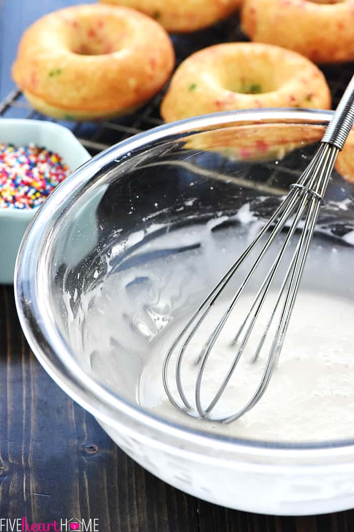 Bowl of vanilla glaze and sprinkles.